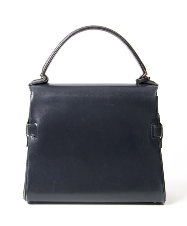 A classic Delvaux style: the Tempete handbag (PM) in navy blue with signature antique brushed gold hardware. 

9