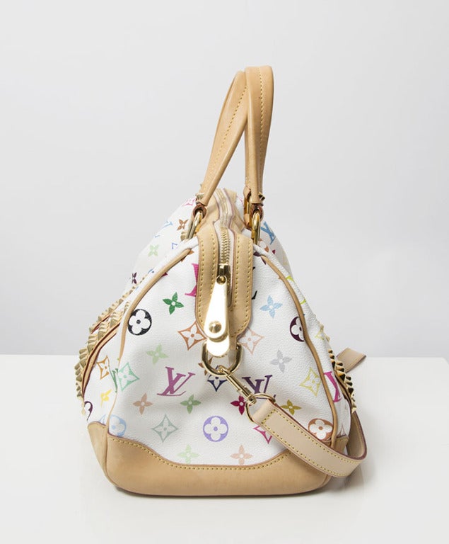 This is an authentic Louis Vuitton Courtney GM Bag with multicolor monogram on white canvas. A collaboration with Murakami and named after Courtney Love. This bag was part of the 2009 collection. It's very rocker chic!
The bag has two natural
