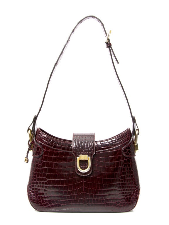 Gorgeous elegant Delvaux bag made from shiny crocodile hide in rich burgundy hue. Features gold plated hardware throughout.