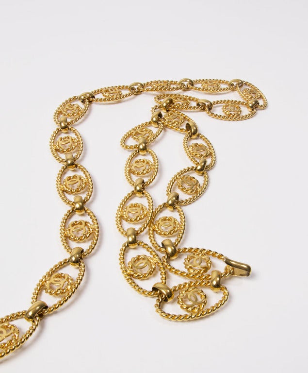 Chanel gold-plated belt with interlocking Cs and rope detailing at the links. Adjustable length and hook-and-eye clasp.