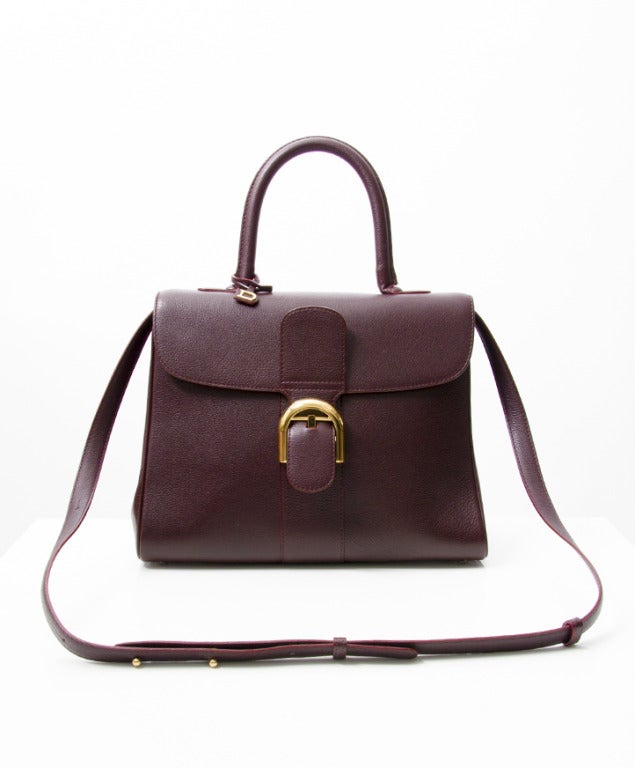 Authentic Delvaux Brillant MM handbag. Color is a beautiful burgundy hue, with yellow gold hardware and contrast stitching. Handmade in Brussels, Belgium. An iconic piece!
Comes with pocket mirror, attachable shoulder strap and original dustbag.