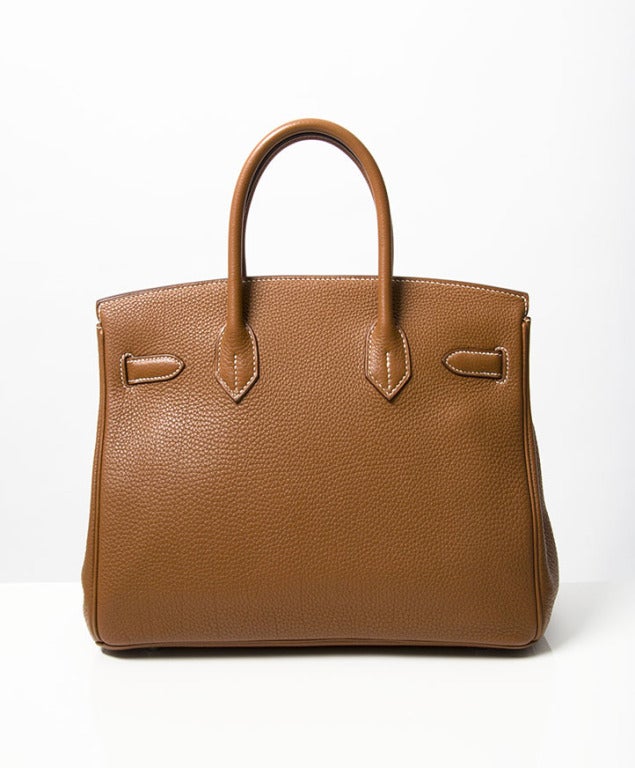 This beauty is in excellent condition. Maybe worn once…
Hermes Birkin 30 cm cognac color PHW.
Blindstamp M in a square. Comes with box and papers.
