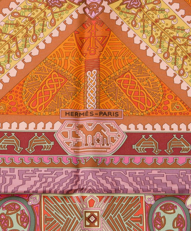 Hermes Silk Scarf Foulard Carre 'Sur Un Tapis Volant'. In warm reds, oranges, yellows and pinks. Perfect hues for blondes and brunettes alike.