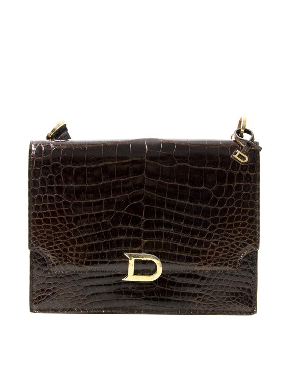 Delvaux brown croco shoulder bag. With pale gold-tone hardware and signature 'D' closure. 

Dimensions:
24cm x 18cm x 4cm 
9.5