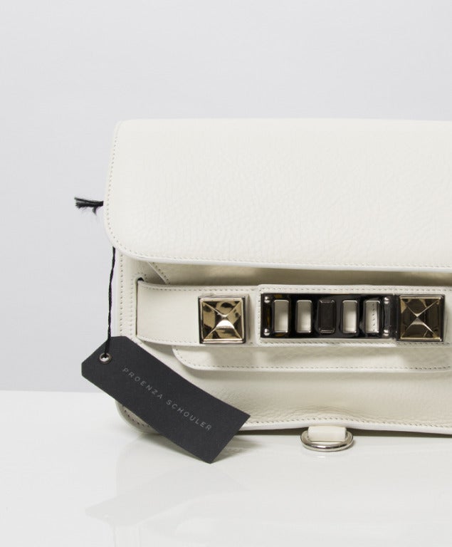Proenza Schouler PS11 mini classic old matt white shoulder bag. The iconic, studiously designed Proenza Schouler PS11, presented in casual crossbody form with enduring leather and a healthy dose of hardware. Matte pebbled calfskin. Organic vegetable