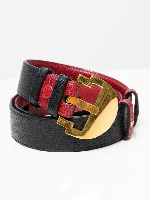 Delvaux red and black leather belt. Golden D buckle with subtle 