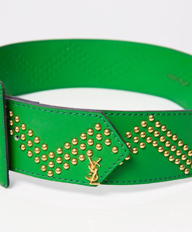 Yves Saint Laurent belt made from smooth green leather with golden studs.