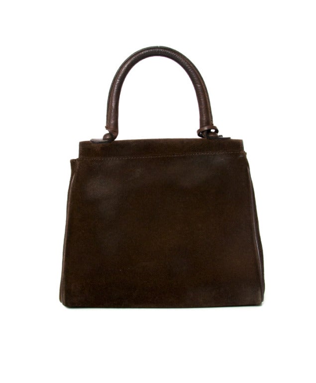 Delvaux Brillant PM handbag in brown suede with silver hardware. 
Leather flap front handbag with rolled top handle and distinctive 