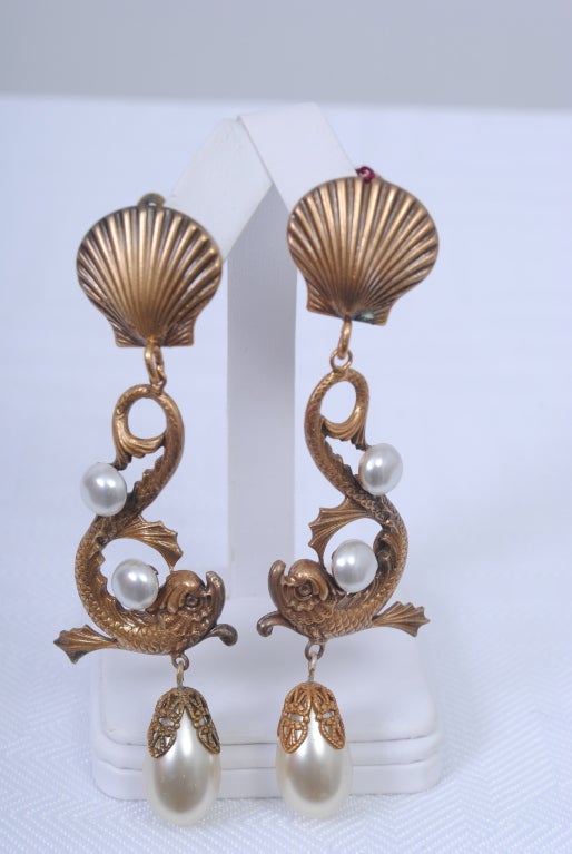 Joseff of Hollywood long drop earrings, the central element a decorative dolphin balancing two pearls and suspending a large ovoid pearl. The ear clip is a shell from which the dolphin drops. Wonderful proportion and very flattering on. Marked
