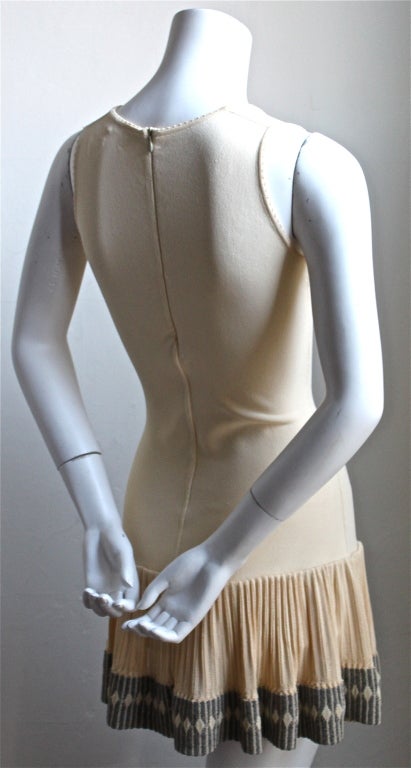 Peach knit mini dress with grey trim from Azzedine Alaia dating to the early 1990's. Dress is labeled a size S. Built in shorts and center back hidden zip closure. Made in Italy. Excellent condition.