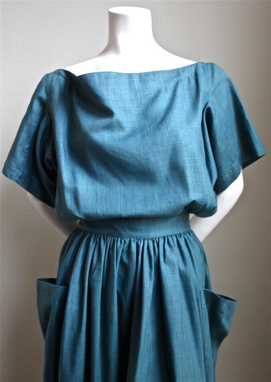 Turquoise linen dress with cut out back and wrap around pockets from Azzedine Alaia dating to the late 1980's. Labeled a French size 38. Approximte measurements are as follows: 26
