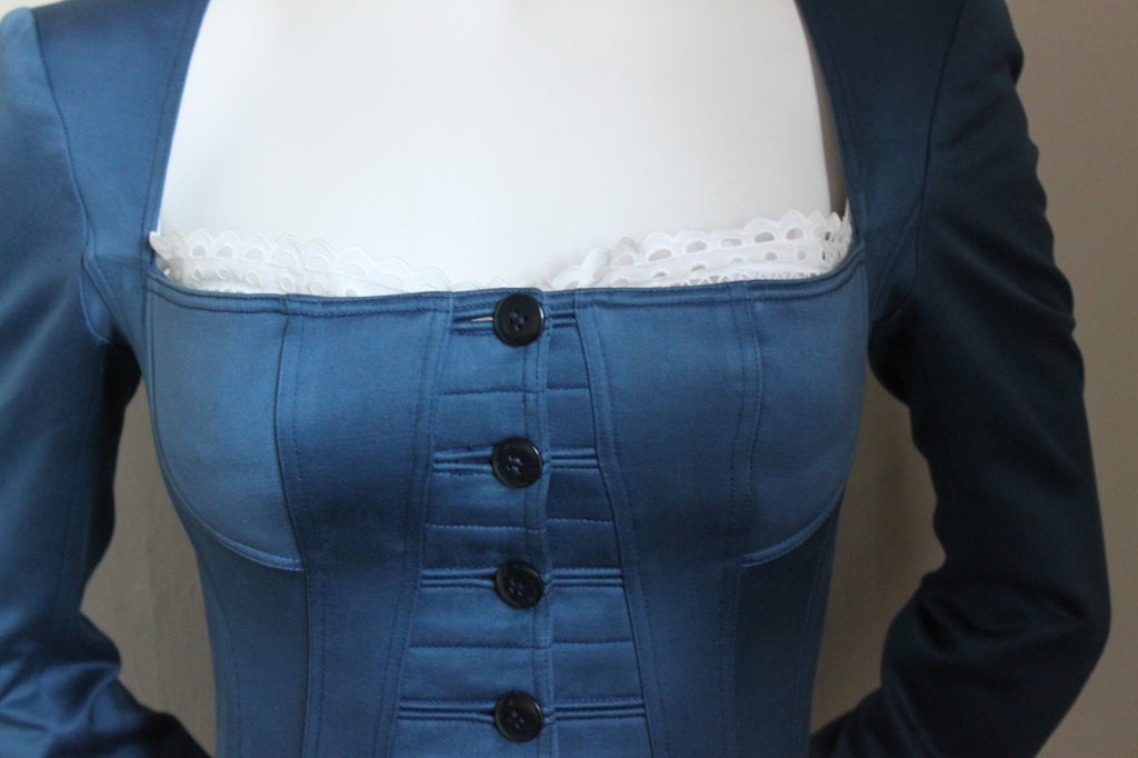 Very rare navy blue suit with corset and eyelet trim from Azzedine Alaia dating to spring/summer of 1992. Suit fits a US size 2. Made in in France. Very good condition (very small barely discernible faded area on front bottom and stitching marks to