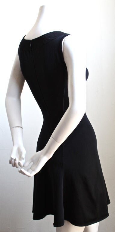 Jet black flared mini dress designed by Azzedine Alaia dating to 1990. Labeled a size XS, although this can easily fit a size small as well. Unstretched approximate measurements are as follows: bust 29