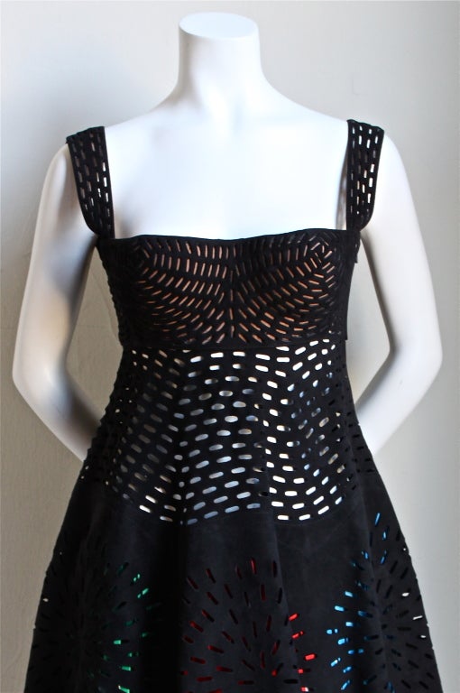 Very rare jet black suede laser cut dress with colorful fringed leather underlay from Azzedine Alaia dating to 1994.  Dress fits a size 2 or 4. Approximate measurements are as follows: bust front 18