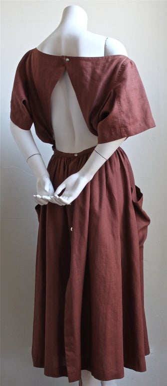 Very rare terra cotta linen dress with cut out back and wrap around pockets dating to the late 1980's. Dress best fits a size 4/6. Made in France. Very good condition.