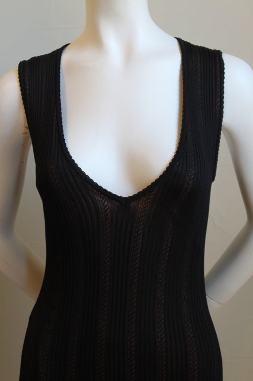 Jet black semi sheer pointelle knit dress with nude lining and deep V neckline designed by Azzedine Alaia dating to the early 1990's. Dress best fits a size M. Approximate measurements are as follows: bust 32