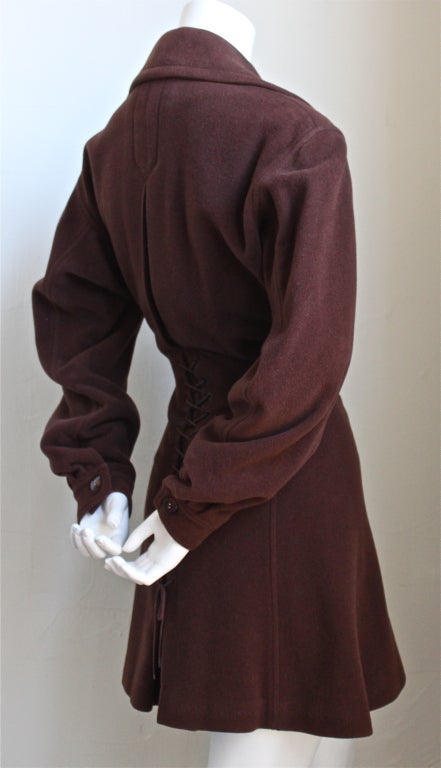 Chocolate brown wool coat with lace up corset back and asymmetrical closure fro Azzedine Alaia dating to the late 1980's. Coat fits a size 6-8. Made in France. Good condition.