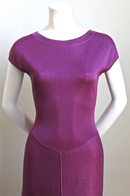 Vivid magenta viscose dress with asymmetrical hemline from Azzedine Alaia dating to spring of 1992. Labeled a size 'S', although this will also fit a size XS. Built in shorts and snap closure at back of neck.  Made in Italy. Excellent condition.