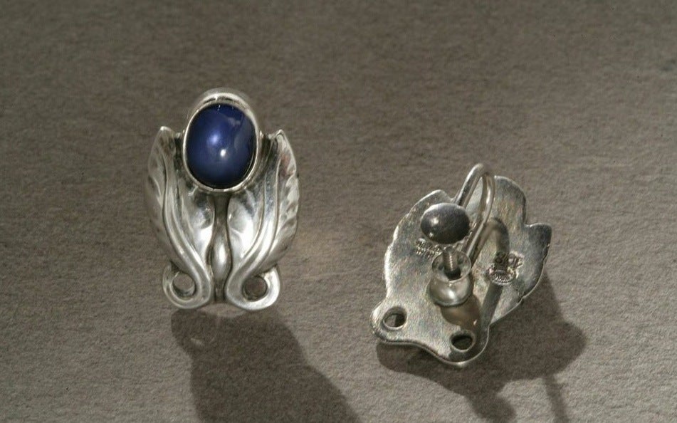Georg Jensen sterling silver earrings with classic foliate design, no. 108 with blue synthetic sapphire.
Screw backs. Circa 1940's. Denmark.