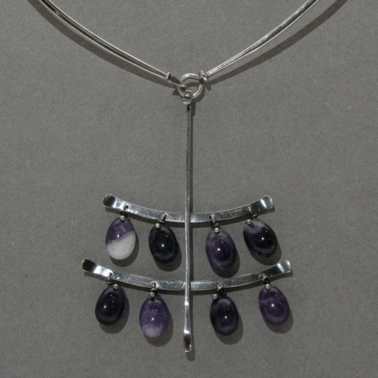 Stunning layers of amethyst drops on large pendant with hook fasten. Featured on neck ring, no. 174, 5.5 inches by 6 inches, included in price. Other neck rings available.
 
Vivianna Torun Bulow-Hube, know as Torun was born on December 7, 1927 in