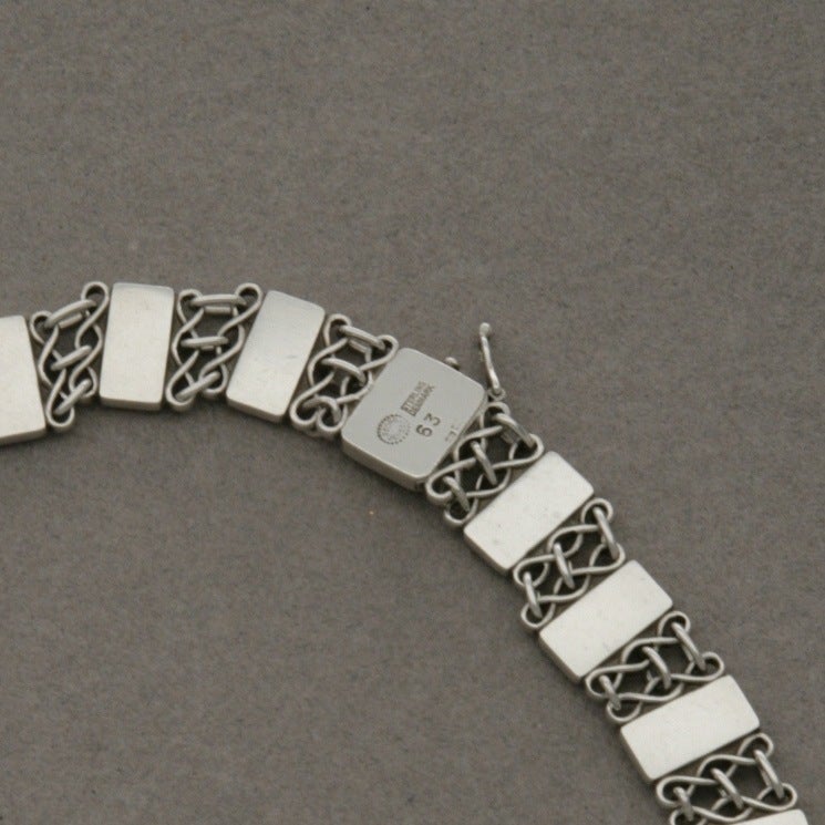 Intricate sterling silver rectangles alternating with a series of patterned chain links for an elegant, understated piece. Measures 14 inches in length.