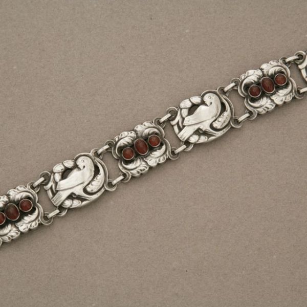 Georg Jensen sterling silver bird bracelet, no. 14 with Garnet stones designed by Kristian Mohl-Hansen. Hallmark dates production from 1945 to 1951.

Complimentary gift box and FREE shipping included.

About the designer:
Kristian Mohl-Hansen was