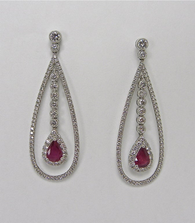 Very feminine drop Ruby and Diamond earrings with floating pear shape Rubies