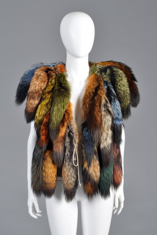 Spectacular Don Kline 1980s rainbow fox tail vest. AMAZING find. We have had many similar tail vests in the past but never a rainbow colored one! Pale taupe wool with applied tails + tying front closure. Absolutely amazing piece! Excellent vintage