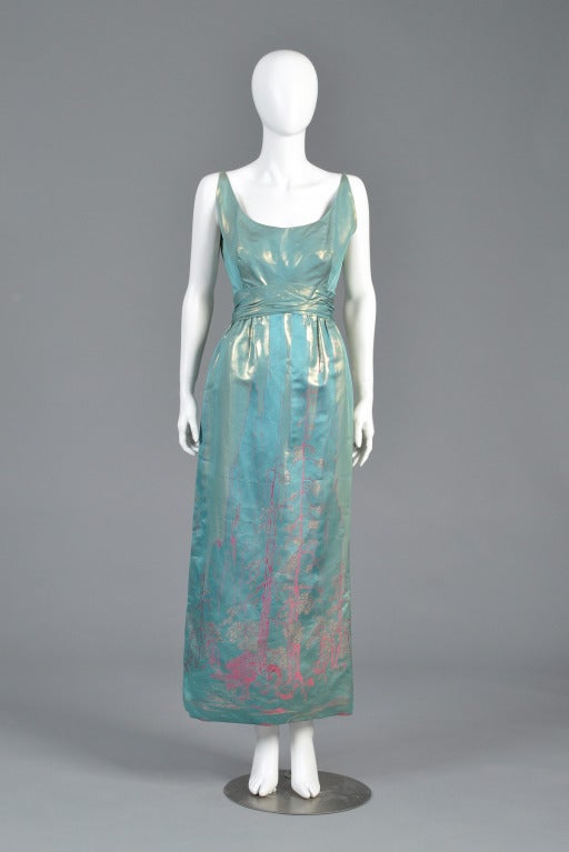 Stunning vintage 1960s Malcolm Starr metallic brocade silk gown. Deep scooping neckline with wide-set straps + attached gathered sash.  Incredible Japanese-inspired pattern with massive trees, small huts + boats. Incredible color palette - our