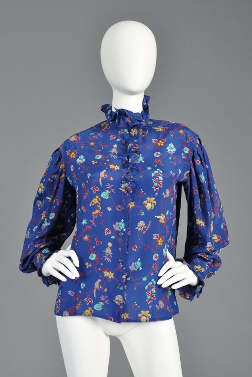 Beautiful 1970s Ungaro Parallele silk blouse. Ruffled yoke and collar. Birds and floral print. Enormous blouson sleeves with extra long ruffled cuffs. Made in Italy. Excellent condition.

MEASUREMENTS
Bust: 41