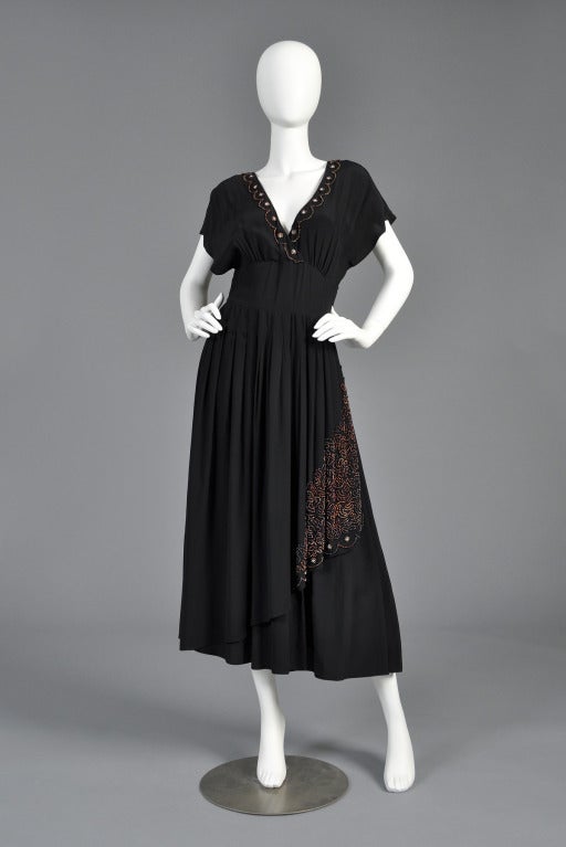 Beautiful and oh-so-feminine vintage 1970s dress by Karl Lagerfeld for Chloe. Perfect LBD with draped + tiered skirt covered in Deco-inspired scalloped beading. Plunging neckline + back trimmed with scalloped beading and rhinestones. Made in