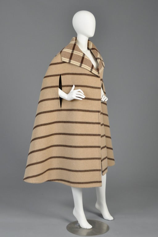 Absolutely spectacular late 60s/early 70s Pauline Trigere reversible striped cape. Incredible find! Simple + chic, this cape features a reversible, contrasting plaid + striped pattern, huge collar and simple slit arm holes. Designed to be worn open.