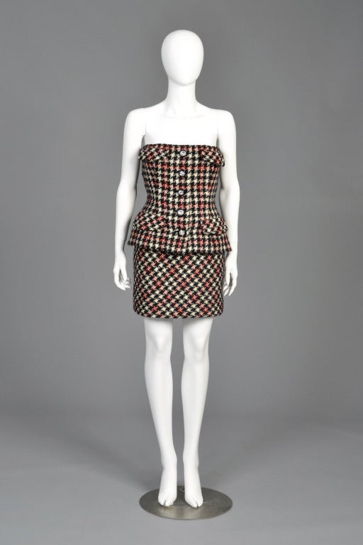 Super adorable vintage 1980s/early 90s Bill Blass mini dress. Nubby houndstooth wool with faux pockets + rhinestone button front. Constructed to look like 2 pieces but is actually just one piece. Zips in back. Fully lined in silk with hidden