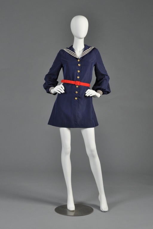 Classic and highly collectible Betsey Johnson for Paraphernalia mini sailor dress. Gold button front with long puffed sleeves and drape collar. Includes the original red belt. Excellent vintage condition - there are a few very very faint spots on