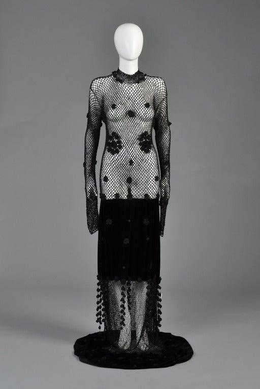 Superb deadstock A/W 94/95 Moschino Cheap + Chic Evening gown. Entirely sheer crocheted bodice with high neck + dramatic ultra long sleeves (we show them pushed all the way up and left hanging). Scattered crochet rosettes decorate the entire piece