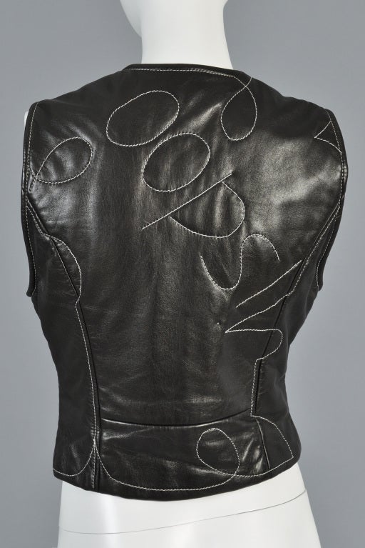 Super sweet 1990s Moschino leather vest. Ultra fitted with plunging neck + zip front. Top stitched crazy details with hearts + accidental 
