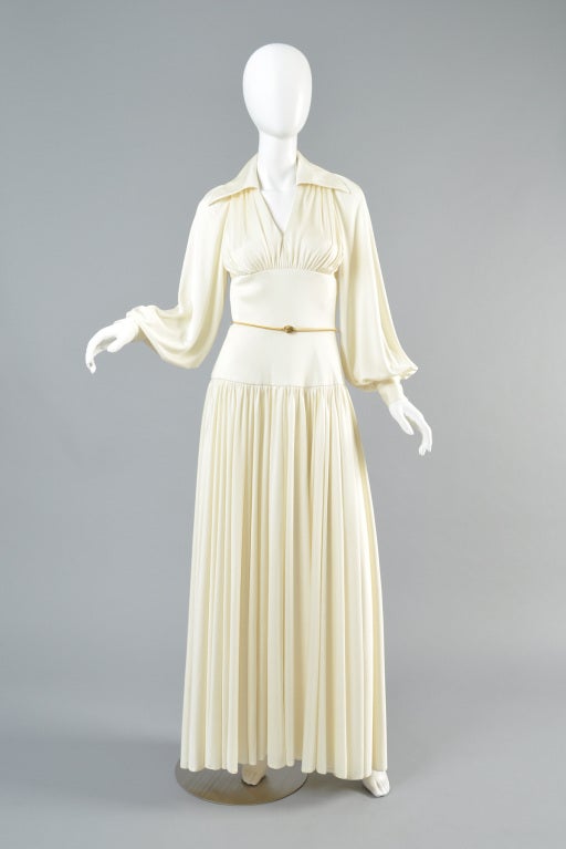 Stunning vintage 1970s Estevez goddess gown. Incredible piece. Grecian influenced draping. Plunging neckline with huge collar. Ruched bodice with fitted midriff + hips. Ultra draped sleeves. Skirt features bias cut jersey that rides slightly shorter