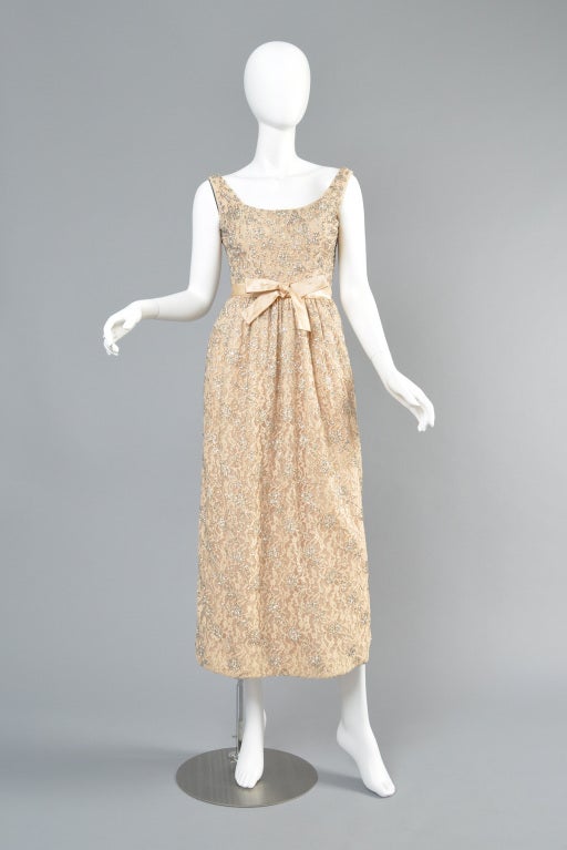 Lovely Herbert Sondheim 1960s pale ivory-beige lace gown. Fully beaded and studded with rhinestones. Scoop neck and silk bow at the waist.