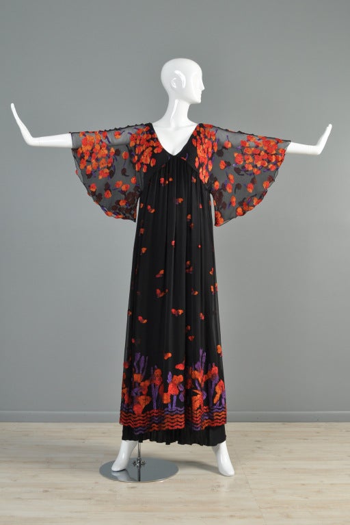 Magnificent vintage 1970s Janice Wainwright black silk evening gown. Art nouveau inspired construction + by far the best Janice Wainwright piece we've seen! Ultra long black silk under dress hangs to the floor while the wider, sheer silk draped top