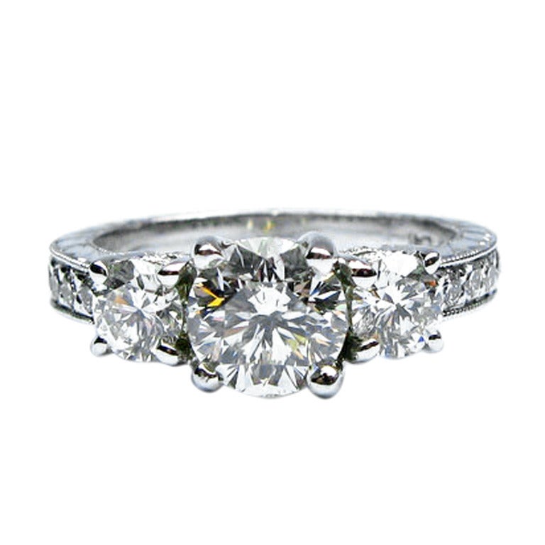 1.76 carats H SI1 Round Brilliant 3-Stone Engraved Ring