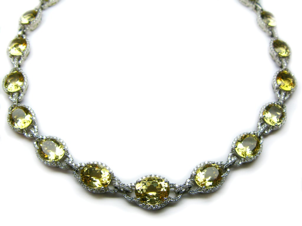 This elegant necklace is sure to turn heads. Twenty-one yellow, oval beryl stones shine while surrounded and linked together by diamond pave all set in 18k white gold. There is also a matching bracelet for this piece (not included).