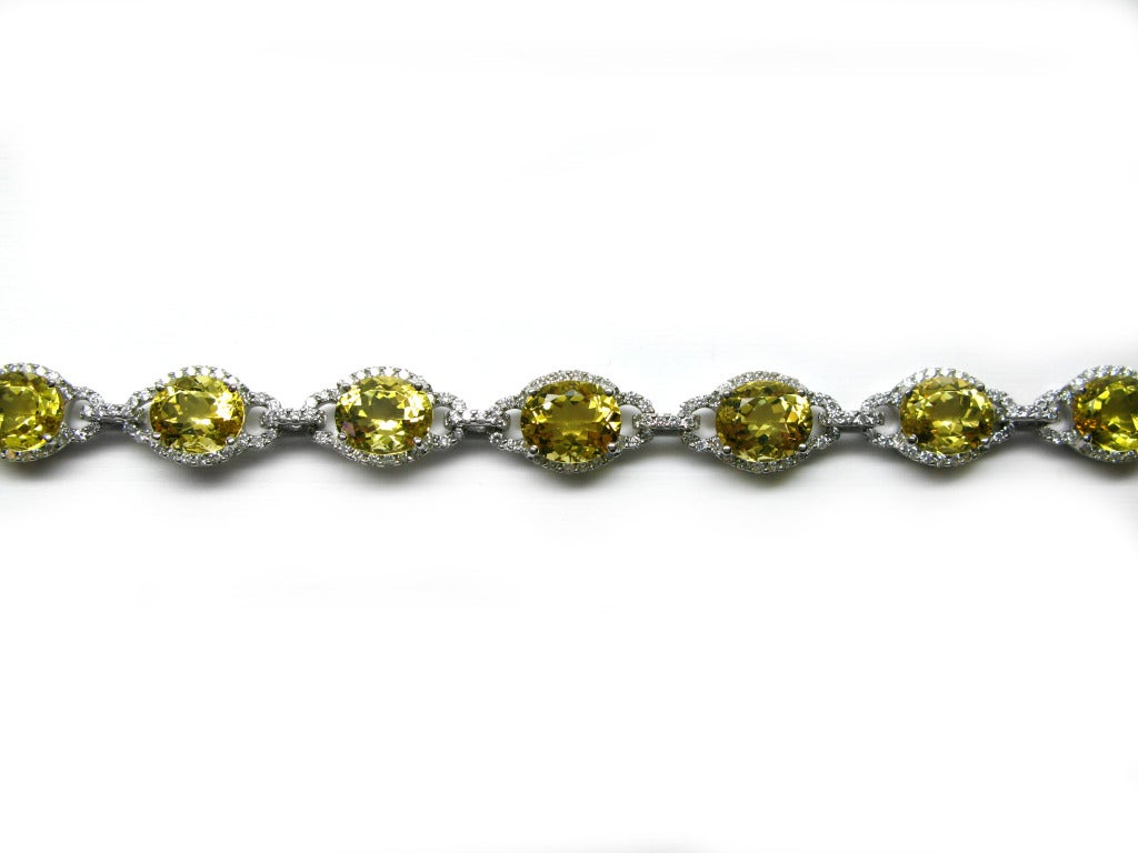 This stunning and unique beryl and diamond bracelet is sure to shine! Set in 18k white gold, the bracelet contains 8 beautiful oval cut yellow beryl stones all surrounded and linked together by white pave diamonds. There is also a matching necklace