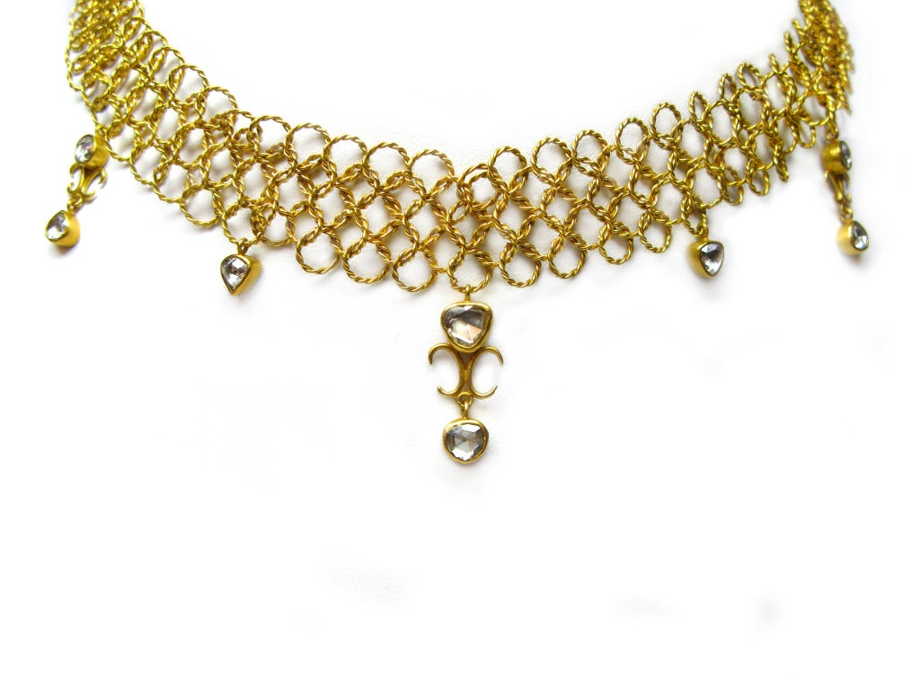 This lovely 22KT yellow gold renaissance style necklace highlights 8 beautiful bezel set rose cut diamonds that all dangle from an exquisite link chain style frame. This piece measures 16