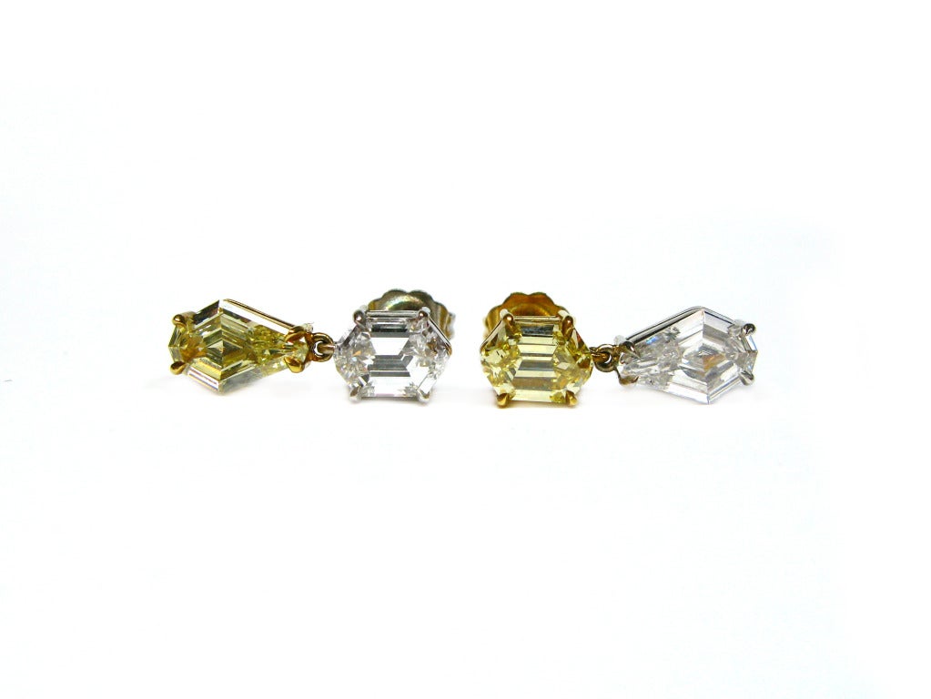 These unique and sophisticated yin & yang earrings are the perfect combination of classy and fun. Each kite-shaped earring features a fancy yellow diamond and a D/E color VS clarity white diamond, but the earings are flipped images of one another,