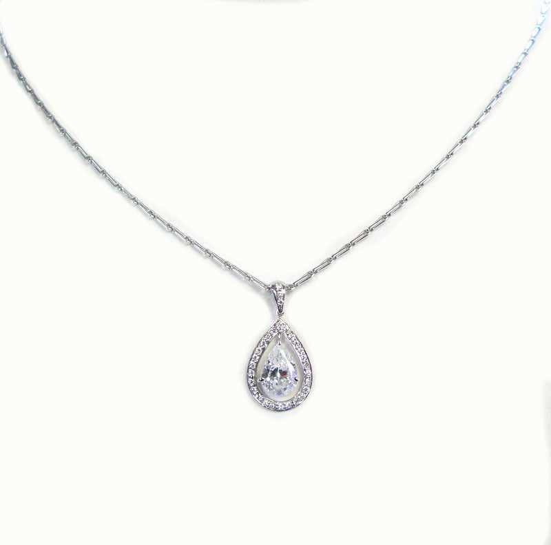 This lovely 1.55ct D color SI2 clarity pear shaped diamond is framed by 0.18 carats of pave diamonds and hangs from an 18kt white gold necklace. This beautiful pendant is extremely versatile and will go great with everything in your wardrobe.