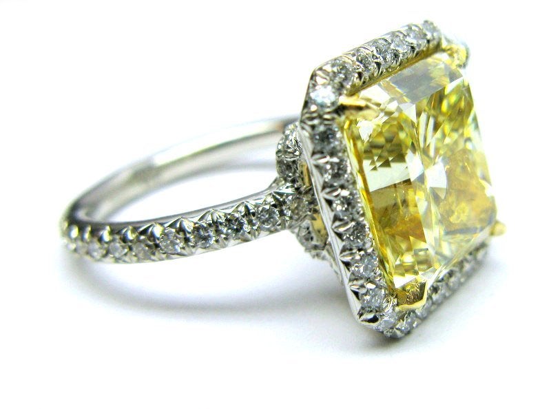 Big and beautiful, this 6.06 carat fancy yellow radiant diamond is surrounded by approximately 1.25cts of pave all set in platinum. Comes with GIA Certificate #14933832 stating that this diamond is graded as a Fancy yellow VS1.