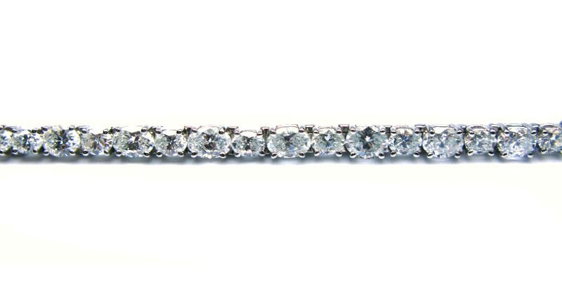 Simple, yet distinctively different line bracelet made with alternating size oval diamonds. A beautiful piece for both day and evening wear.