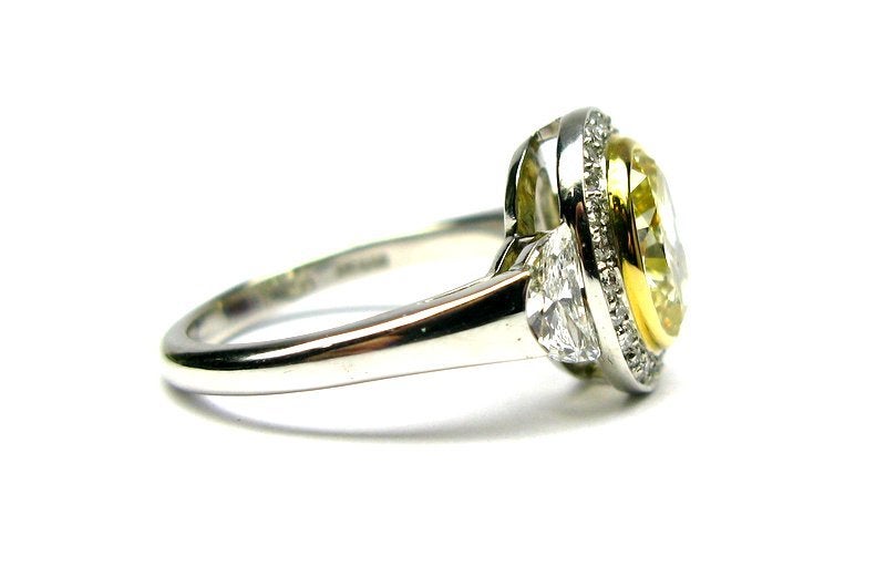 Contemporary 2.07ct GIA Fancy Yellow SI1 Oval Diamond Frame Ring