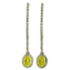 4.31 carats Fancy Yellow Vivid and Intense Oval Diamond Dangle Earrings