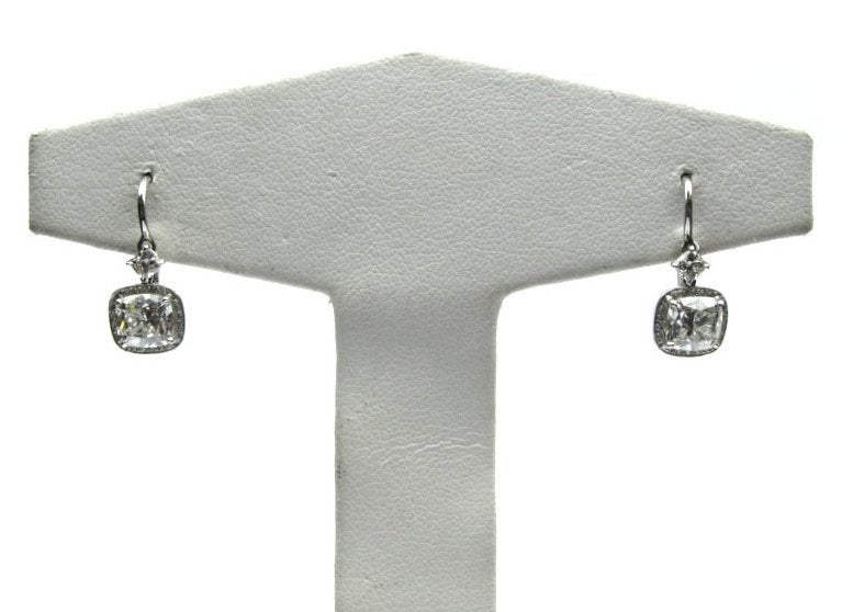 These lovely cushion cut diamond dangle earrings feature a 1.00ct VS1 and a 1.01ct VS2 diamond both GIA certified. These earrings also contain 0.30cts of pave diamonds and 2 small cushion cut diamonds totaling 0.24cts.